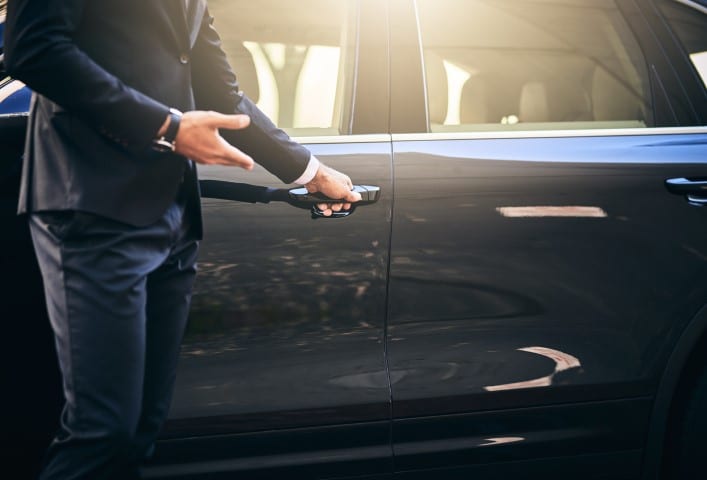 Private driver opening door - JFK ground transportation