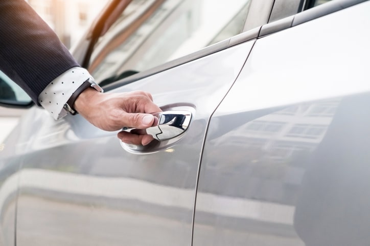 Private driver / chauffeur with hand on door handle