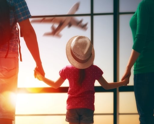 Family travelling to the airport with children