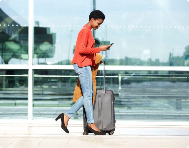 Teddys Professional Customer Service | Woman walking in airport using mobile phone